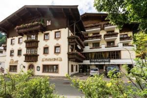a large building with flowers on the balconies of it at Vital Hotel Post in Dienten am Hochkönig