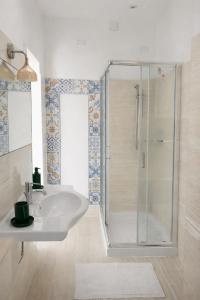 a white bathroom with a shower and a sink at Le VELE in Lido di Ostia +16 photos