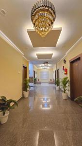 a large lobby with a chandelier and potted plants at White Dove Luxurious Boutique Hotel, within 3 Km from Guwahati Airport in Guwahati