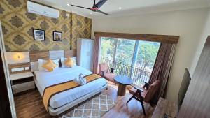 a hotel room with a bed and a balcony at White Dove Luxurious Boutique Hotel, within 3 Km from Guwahati Airport in Guwahati +62 photos