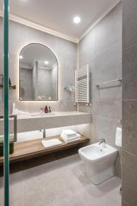 a bathroom with a sink and a toilet and a mirror at Panorama Kakheti Resort in Gurjaani