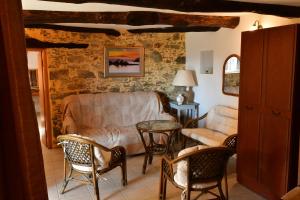 a living room with a couch and chairs and a table at Rogdia Mountain View Apartment in Rogdhiá