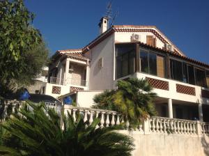 una casa blanca con una palmera delante de ella en La Nectarine, en Niza