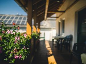 a porch with flowers and a table and chairs at Ferienweingut Hammes in Mülheim an der Mosel