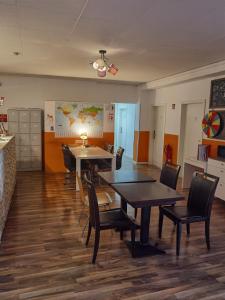 a dining room with two tables and chairs at MAC City Hostel in Hamburg