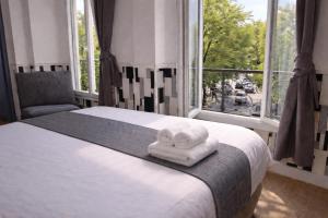 a bedroom with a bed with two towels on it at Hôtel Tilde in Paris +43 photos