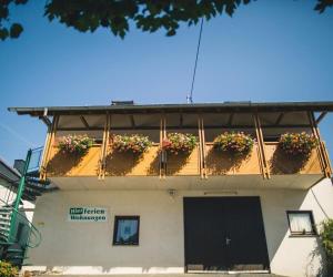 a building with flower boxes on the balcony at Ferienweingut Hammes in Mülheim an der Mosel