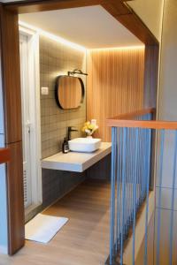 a bathroom with a sink and a mirror at Liorasuite 4 Bedroom Jacuzzi Billiard Pingpong in KBP in Padalarang +25 photos