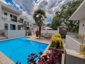 a swimming pool in the backyard of a house at Amoris Guesthouse I - Randburg in Johannesburg