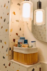 a bathroom with a shelf with products on it at Studio49apartments Quiet in Niš Free Private Parking Fast WiFi in Niš +87 photos