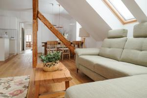 a living room with a couch and a table at Apartmaji Matec in Fala +24 photos