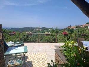 a patio with chairs and a view of the mountains at Campus Natura in Arganil