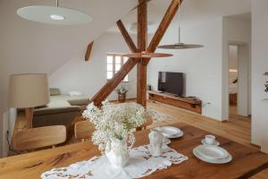 a living room with a table with a vase of flowers at Apartmaji Matec in Fala