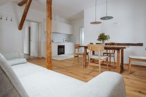 a kitchen and dining room with a table and chairs at Apartmaji Matec in Fala