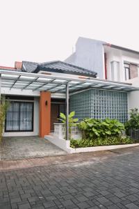 a house with a lot of plants in front of it at Liorasuite 4 Bedroom Jacuzzi Billiard Pingpong in KBP in Padalarang