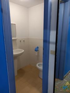 a bathroom with a toilet and a sink at I Love Host 24 in Montefiascone +12 photos