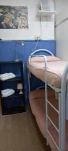 two bunk beds in a room with blue walls at I Love Host 24 in Montefiascone