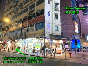 a city street at night with people walking on the sidewalk at Causeway Bay Inn (@Percival Street) in Hong Kong +28 photos