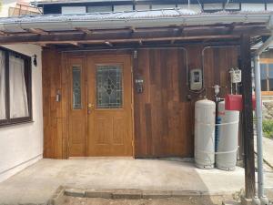 a large wooden door of a house with a gas pump at HANARE onomichi in Onomichi