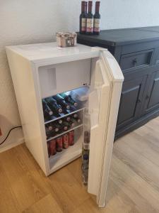 a small white refrigerator with drinks inside of it at Ferienwohnung 'Im Hause Hofland' in Uslar
