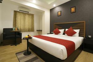 a bedroom with a large bed with a red blanket at Hotel Grand Delta Near International Airport in New Delhi
