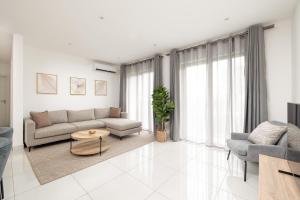 a living room with a couch and a table at The Bantree by Clifton Homes in Accra
