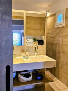 a bathroom with a sink and a mirror at Jemphasis-New Apartments Mykonos in Agios Ioannis Mykonos +36 photos