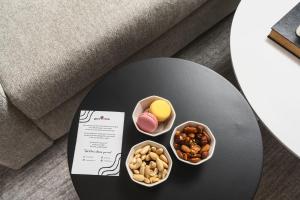 a table with three small bowls of food on it at Corner Residence by GoodMove - Casablanca in Casablanca
