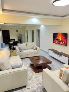 a living room with two couches and a table at pk Luxury Homes in Nairobi