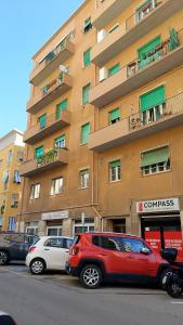 two cars parked in front of a large building at TCEM camera in attico 6 no ascensore in Piombino