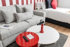 a living room with a couch and a red table at Corner Residence by GoodMove - Casablanca in Casablanca