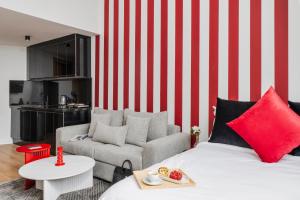 a living room with a red and white striped wall at Corner Residence by GoodMove - Casablanca in Casablanca +27 photos