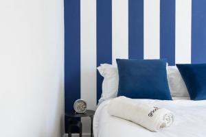 a bedroom with blue and white striped walls and a bed at Corner Residence by GoodMove - Casablanca in Casablanca