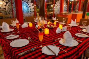 a table with a red and black checkered table cloth at Muthu Mara River Lodge in Masai Mara