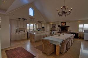 a large kitchen with a table in the middle at Iconic Villa in Arniston in Arniston