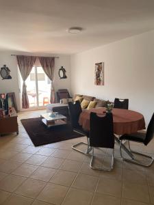 a living room with a table and a couch at SOL AZUL in Santa Maria