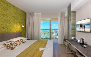 a bedroom with a bed and a view of the ocean at Hotel Joseph in Marina di Pietrasanta +128 photos