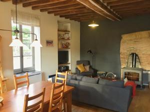 a living room with a couch and a table at La Forge in Sainpuits