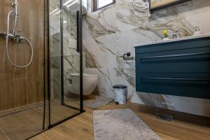 a bathroom with a shower and a toilet at Vikendice Kutlešić in Čajetina +26 photos