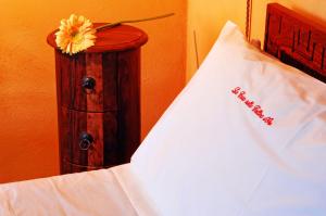a bed with a white pillow on top of it at La Casa sulla Collina d'Oro in Piazza Armerina