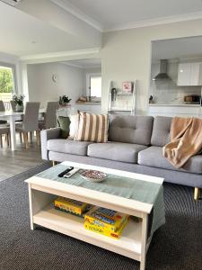 a living room with a couch and a coffee table at Escape on Eighth Poolside Comfort Close to CBD in Mildura