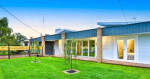 a house with a lawn in front of it at Escape on Eighth Poolside Comfort Close to CBD in Mildura