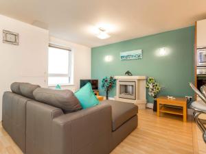 a living room with a couch and a fireplace at Baywatch - Private Balcony Overlooking Poole Quay in Poole