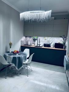 a dining room with a table and chairs and a kitchen at Malishka Eco Villas