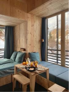 a room with a bed and a table with fruit on it at minipockethouse in Evolène