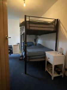 a bedroom with two bunk beds and a table at Freedom hostel in Radcliffe