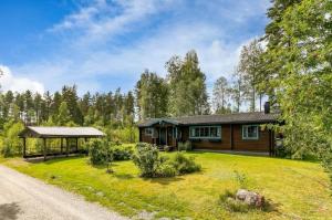 a log home with a gazebo and a yard at ORE798-Ramsberg-Kolarevaegen-2 in Ramsberg