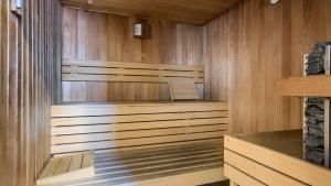 a sauna with wood paneled walls and floors at Welle Resort, Sun & Snow in Grzybowo