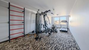 a gym with bikes and tread machines in a room at Welle Resort, Sun & Snow in Grzybowo