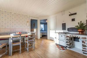 a kitchen with a table and a stove in a room at KRO803-Haeradsbaeck-Ellagoelshult-4 in Häradsbäck